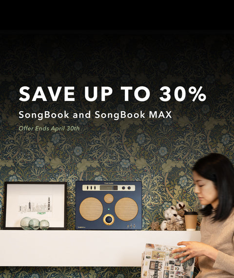 Blue SongBook MAX on a shelf with decorative items against a floral wallpaper background. promo text saying save up to 30%. songbook max. offer ends april 30th.